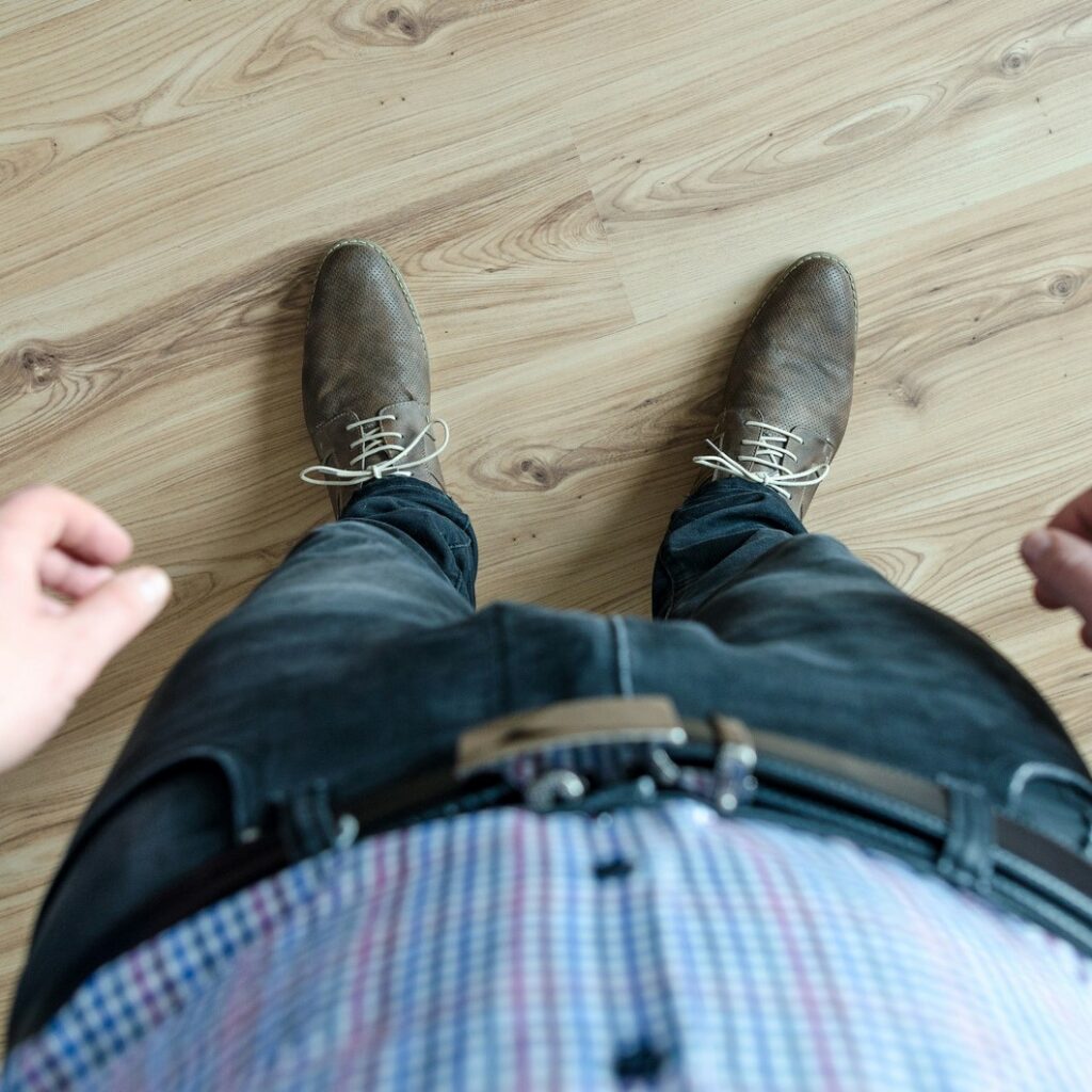 Looking down from above at a man wearing jeans and brown shoes