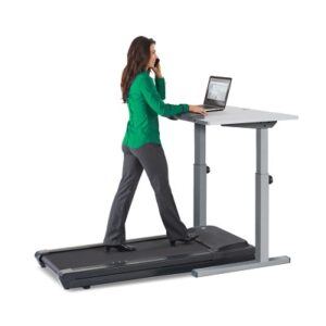 Woman walking on LifeSpan TR1200 treadmill whilst working on her laptop