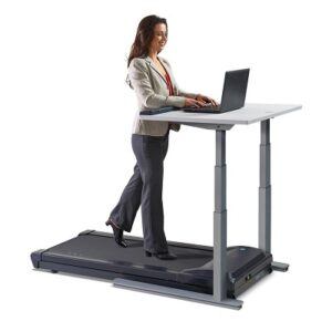Woman walks on LifeSpan TR1200 treadmill whilst working on her laptop