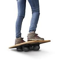 Balance board supporting a person wearing sneakers and denim trousers
