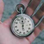 Silver encased stopwatch with white face and black numbering