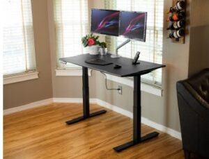 Side angle of the ZipDesk with black worktop and frame supporting dual monitors and laptop