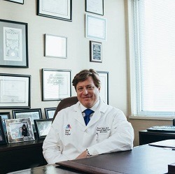 Doctor sitting at desk in his office