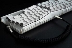 White split ergonomic keyboard against a black background