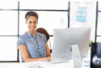 Woman sat as desk in front of laptop