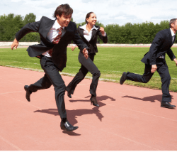 3 people running a race whilst wearing suits