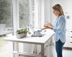 Woman working at semi-adjustable standing desk