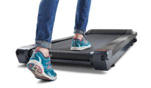 Close up of feet stepping onto a treadmill