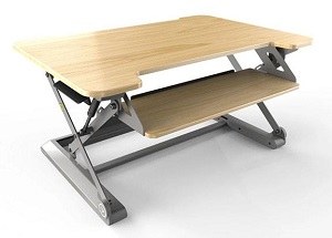 InMovement Desk Converter with gray frame and maple worktops
