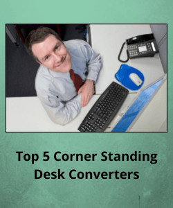 Man looks up smiling from a corner workspace in an office cubicle
