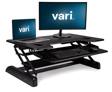 Black VariDesk converter with keyboard, mouse, laptop and monitor